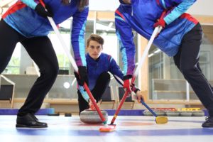 Curling, team playing on the ice